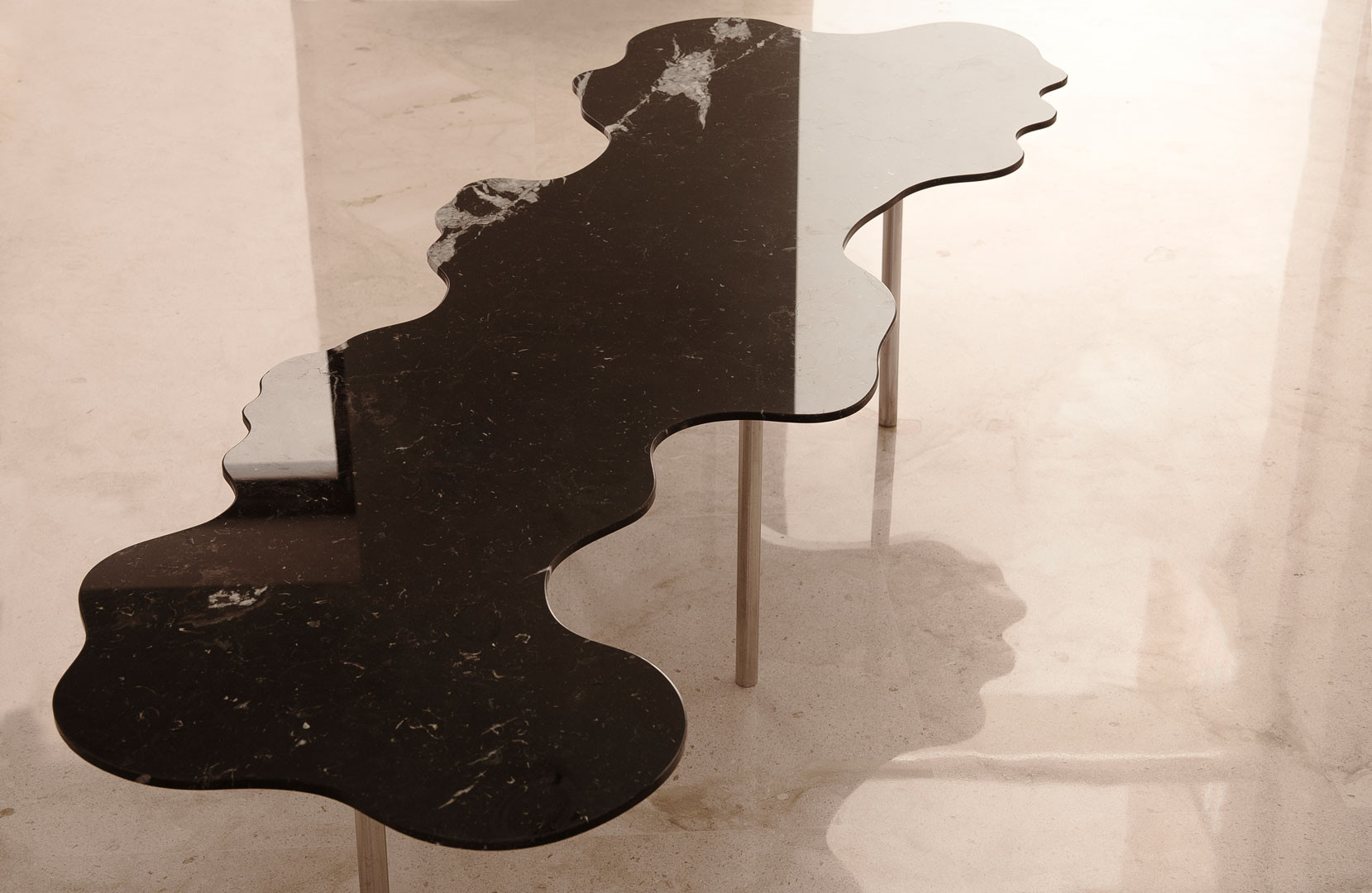 Shadow of the Lago table on the stone floor