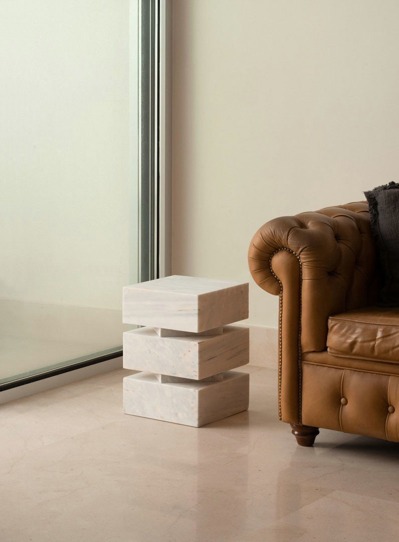 Pilas used as a seat beside a leather armchair