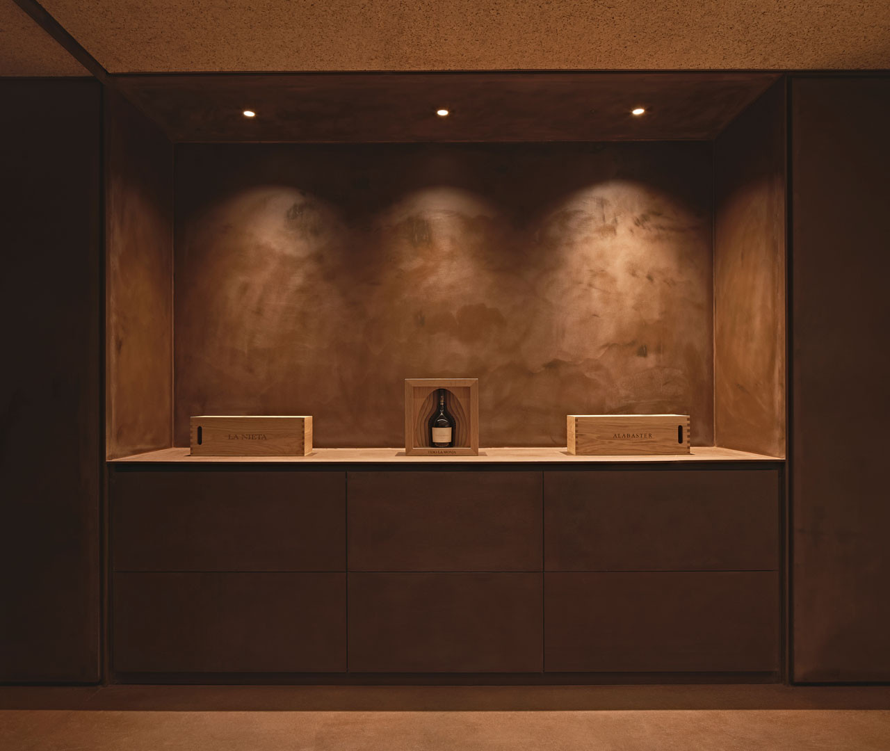 Front of the Tinta room with a low table before the stone wall