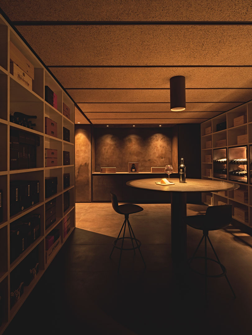 Tinta room with the circular table and the stone niches holding bottles
